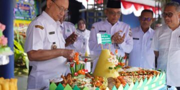 Wali Kota Pontianak Edi Rusdi Kamtono memotong tumpeng saat menghadiri syukuran ulang tahun ke-50 PDAM Tirta Khatulistiwa.