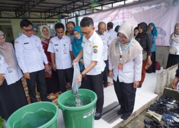 Wali Kota Pontianak Edi Rusdi Kamtono memasukkan benih ikan lele ke dalam ember.