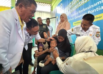 Wali Kota Pontianak Edi Rusdi Kamtono menenangkan seorang balita yang tengah diimunisasi